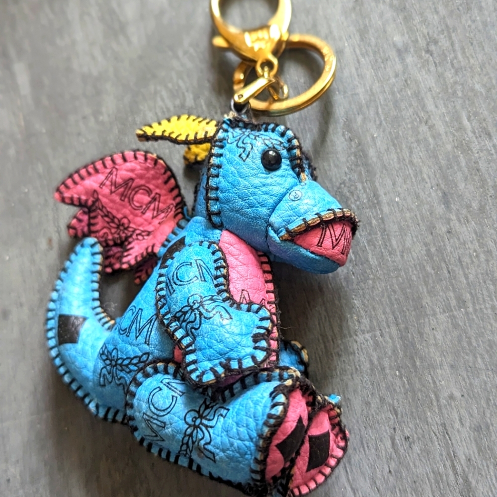 Adorable little MCM dragon in blue and pink, black logo, gold hardware